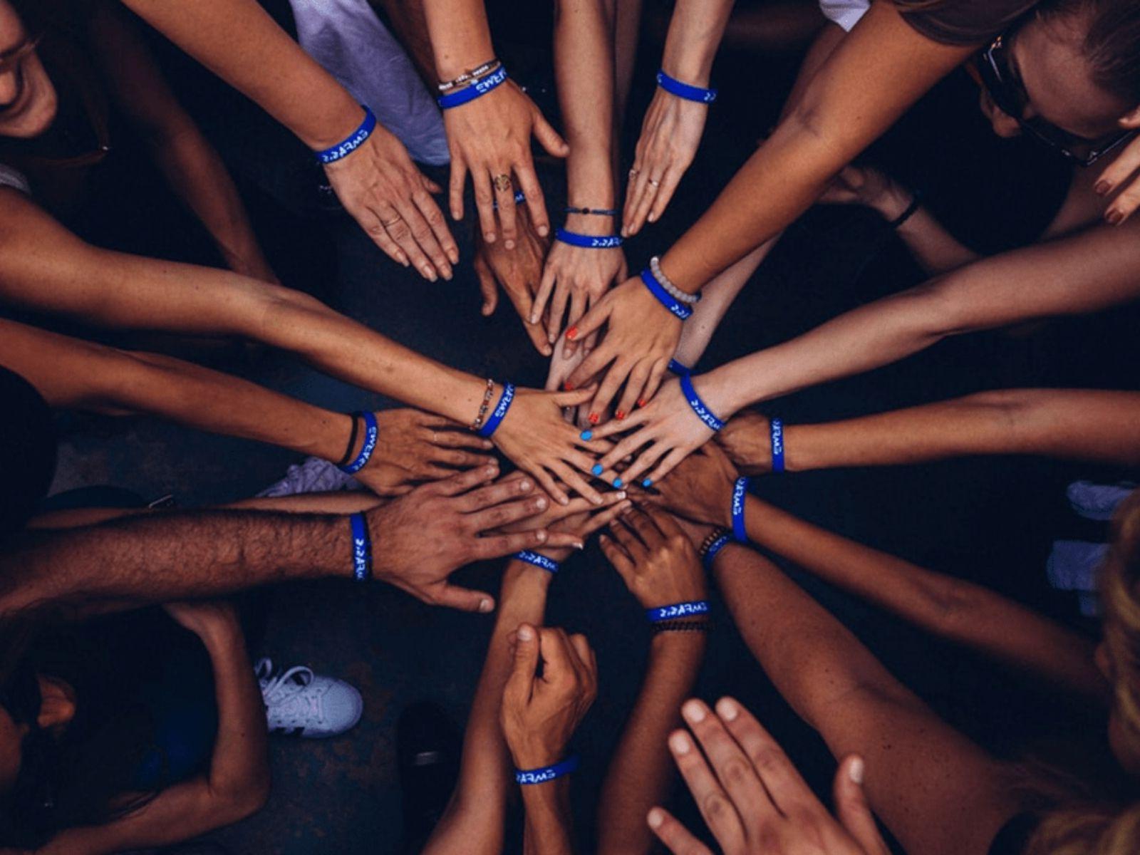 A Group of people putting their hands together